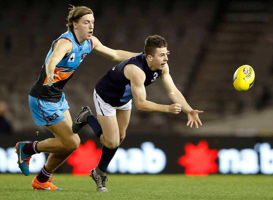 AFL 2016 U18 Championship - Allies v Vic M MELBOURNE, AUSTRALIA - JUNE 24: Jack Higgins of Vic Metro handpasses the ball ahead of Will Setterfield of the Allies during the Under 18 Championship match between the Allies and Vic Metro at Etihad Stadium on June 24, 2016 in Melbourne, Australia. (Photo by Adam Trafford/AFL Media)